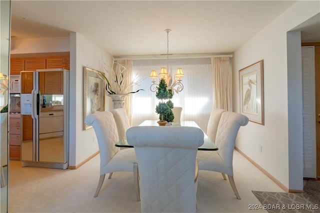 dining area with baseboards, carpet flooring, and an inviting chandelier