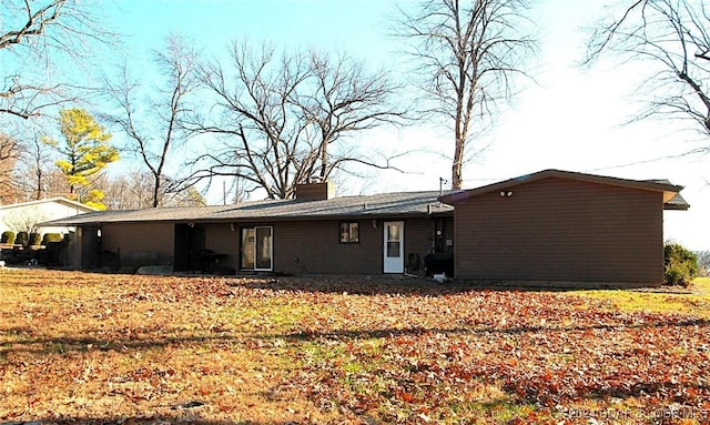 back of house with a lawn