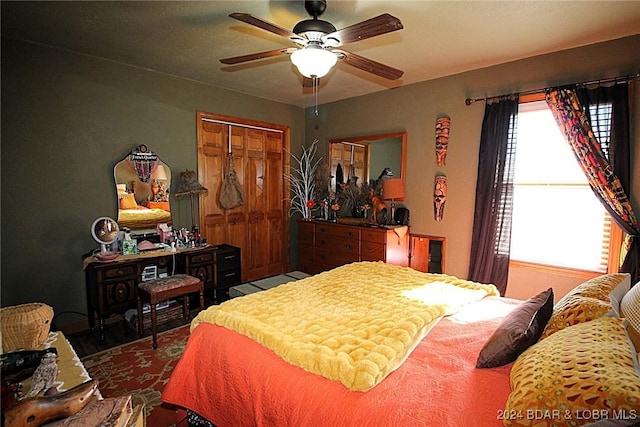 bedroom with ceiling fan and a closet