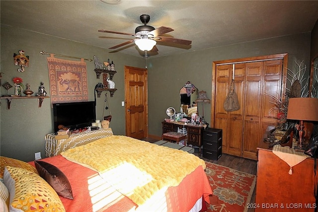 bedroom featuring ceiling fan, a closet, and dark hardwood / wood-style floors