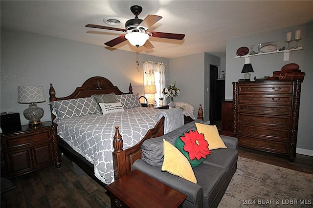 bedroom with ceiling fan and dark wood-type flooring