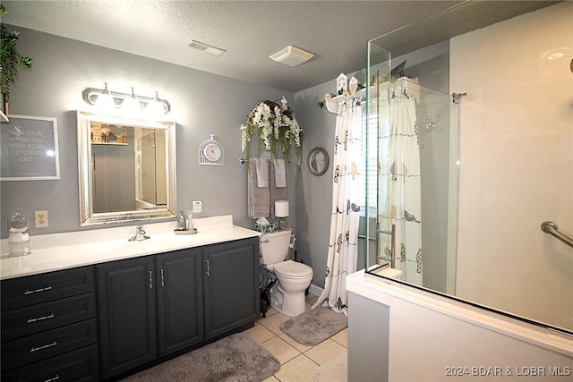 bathroom featuring tile patterned floors, walk in shower, a textured ceiling, vanity, and toilet