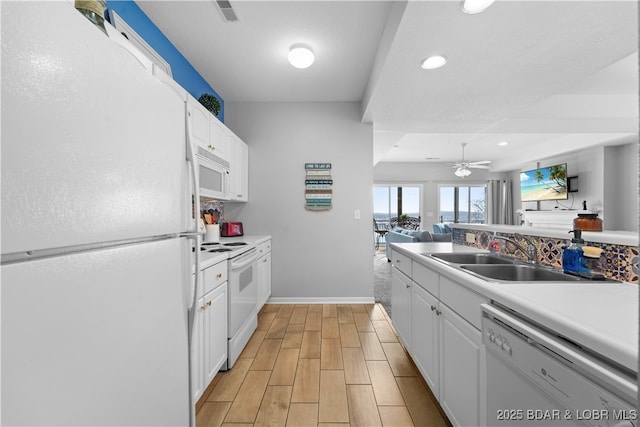 kitchen with ceiling fan, white cabinetry, white appliances, and sink