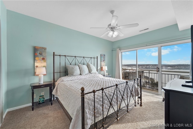 carpeted bedroom with ceiling fan, a water view, and access to outside