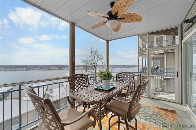 sunroom with a wealth of natural light and a water view