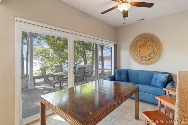 tiled living room featuring ceiling fan