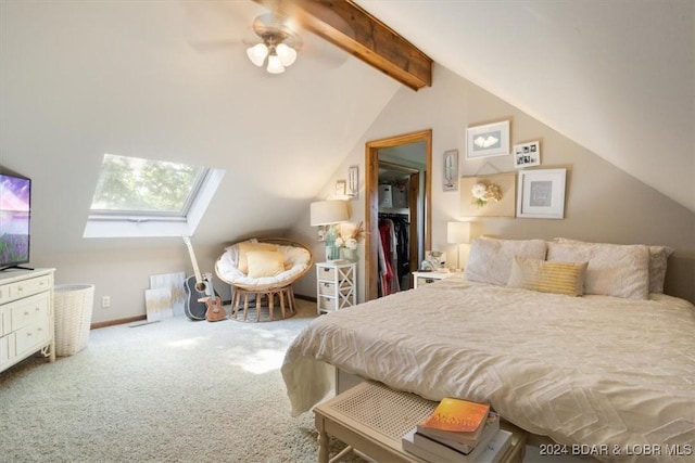 bedroom featuring ceiling fan, lofted ceiling with skylight, and carpet floors