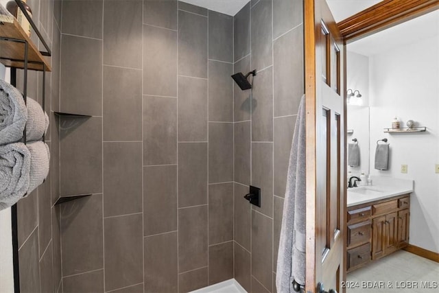 bathroom with vanity and tiled shower