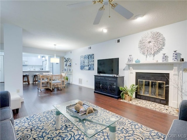 living room with dark hardwood / wood-style floors, ceiling fan, and sink