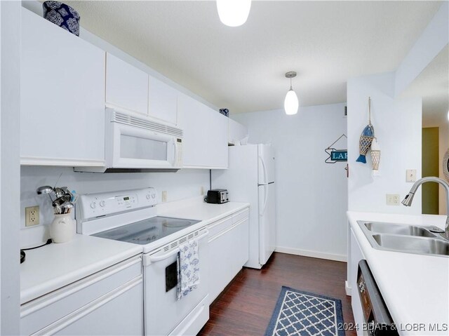 kitchen featuring white cabinetry, sink, hanging light fixtures, dark hardwood / wood-style floors, and white appliances