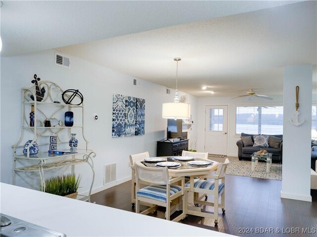 dining area with dark hardwood / wood-style floors and ceiling fan