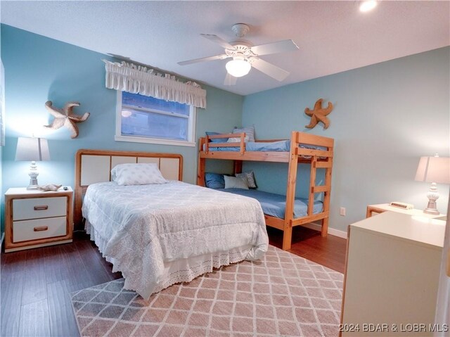 bedroom with dark hardwood / wood-style floors and ceiling fan