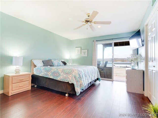 bedroom featuring access to outside, ceiling fan, and dark hardwood / wood-style flooring