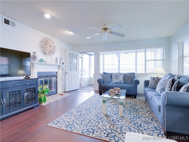 living room featuring dark hardwood / wood-style floors and ceiling fan