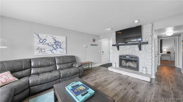 living room with a fireplace and dark hardwood / wood-style floors