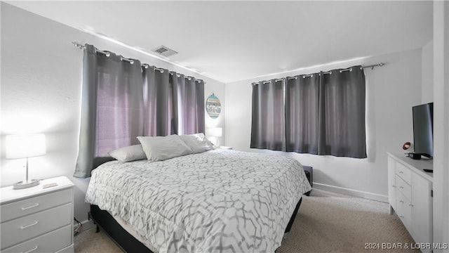 bedroom with light colored carpet