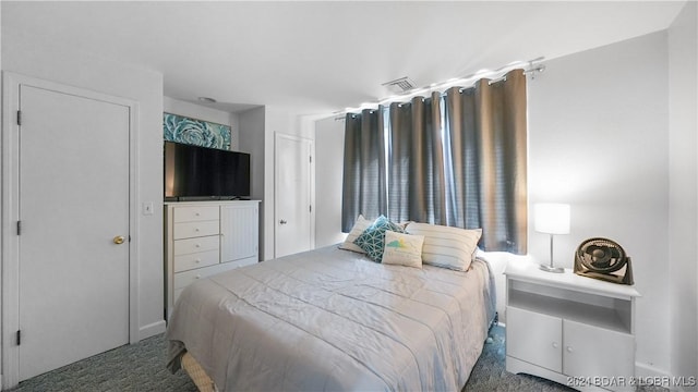 bedroom featuring dark colored carpet