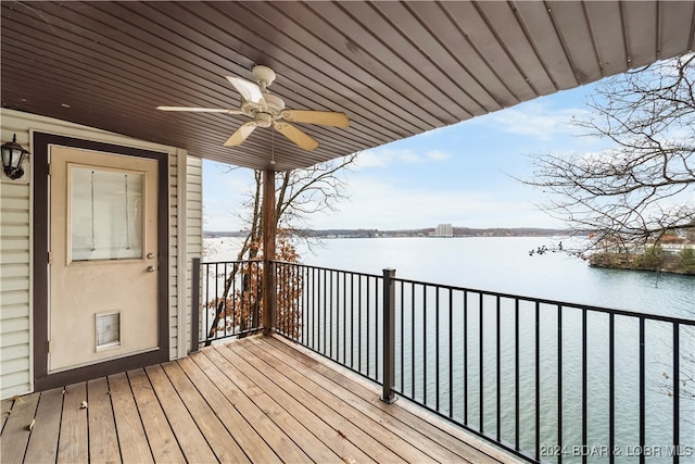 deck with a water view and ceiling fan