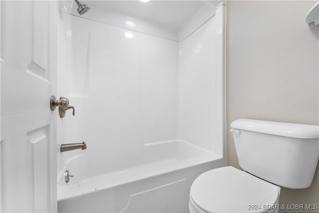 bathroom featuring shower / bathing tub combination and toilet