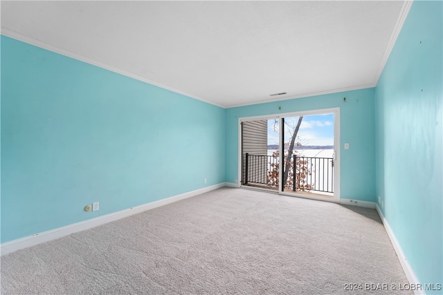 carpeted empty room featuring crown molding