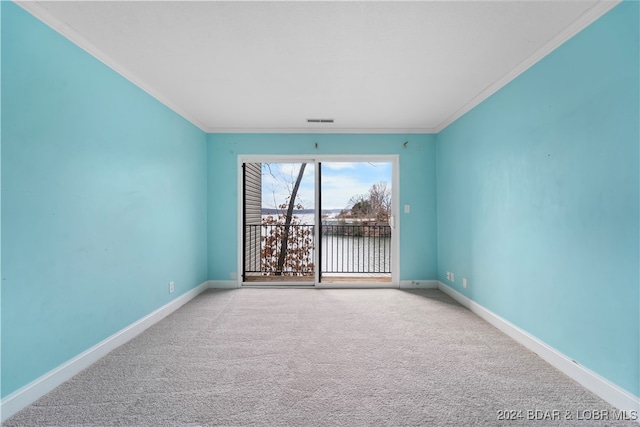 empty room with crown molding and light carpet