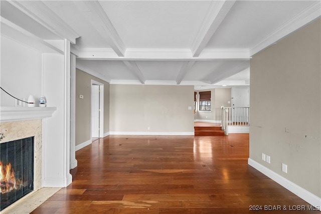 unfurnished living room with a fireplace, beam ceiling, hardwood / wood-style flooring, and crown molding