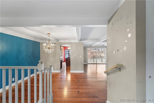 interior space featuring ornamental molding, coffered ceiling, beam ceiling, hardwood / wood-style flooring, and a chandelier