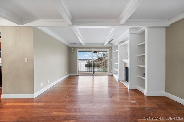 unfurnished living room featuring coffered ceiling, crown molding, beam ceiling, built in features, and hardwood / wood-style floors