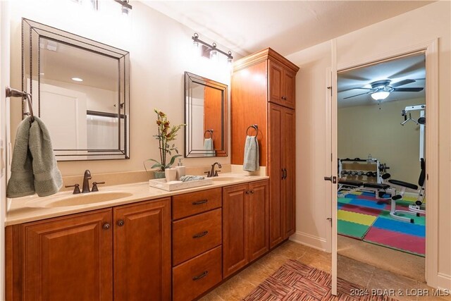 bathroom with tile patterned flooring, ceiling fan, and vanity