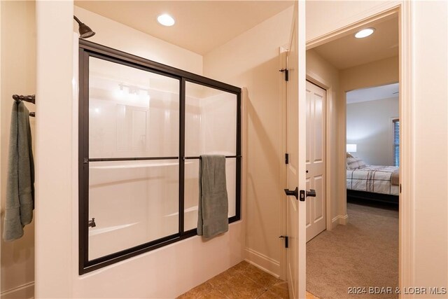 bathroom featuring a shower with door