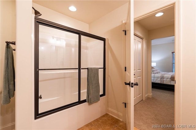 bathroom with a shower with shower door, tile patterned floors, and recessed lighting