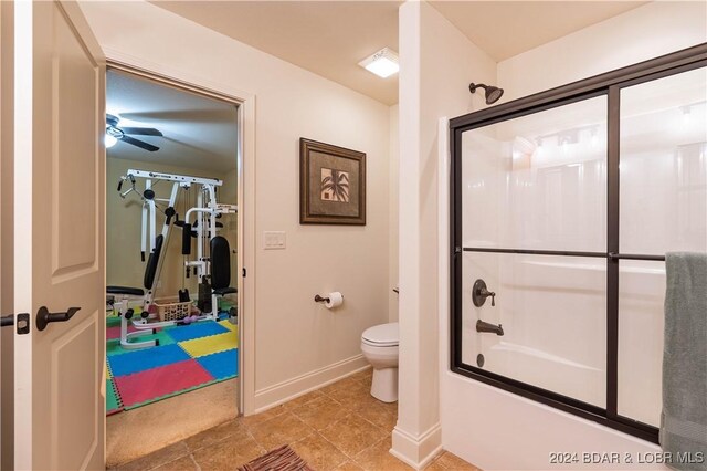 bathroom featuring ceiling fan, bath / shower combo with glass door, and toilet