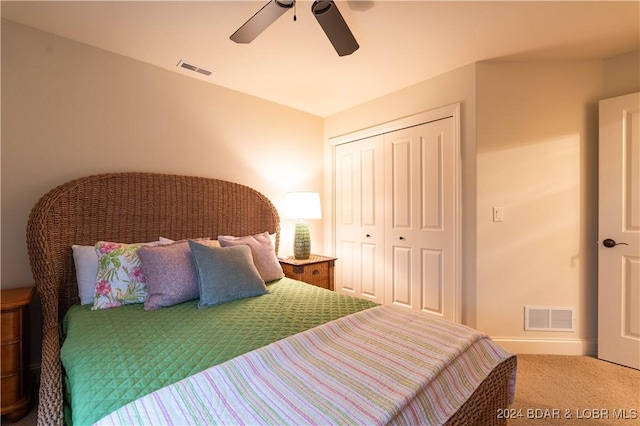 carpeted bedroom with a ceiling fan, visible vents, and a closet