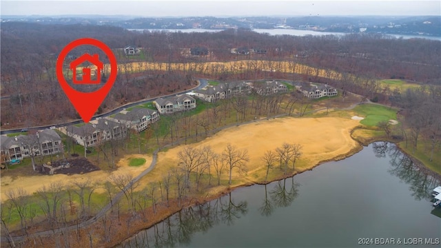 aerial view featuring a water view and a wooded view