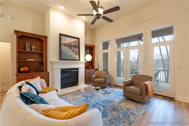 living room with ceiling fan and light wood-type flooring