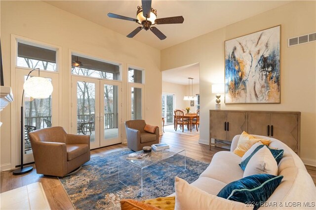 living room featuring hardwood / wood-style floors, ceiling fan, and french doors