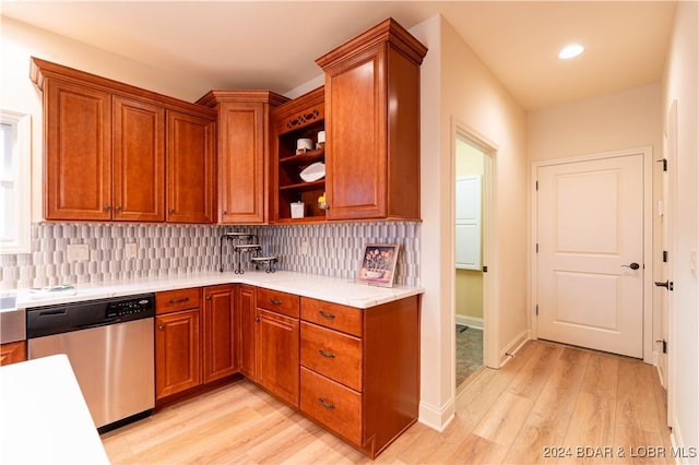 kitchen with backsplash, dishwasher, and light hardwood / wood-style flooring