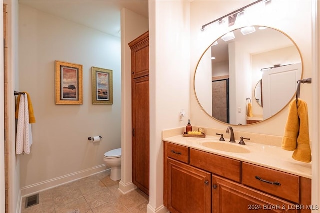 bathroom featuring tile patterned floors, vanity, and toilet