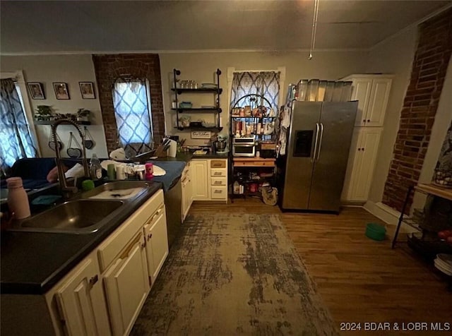 kitchen featuring a wealth of natural light, stainless steel fridge with ice dispenser, sink, and dark hardwood / wood-style floors