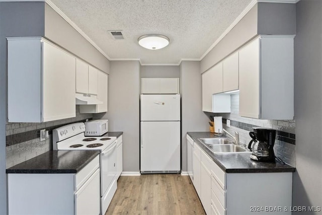 kitchen with sink, white cabinets, light hardwood / wood-style floors, and white appliances