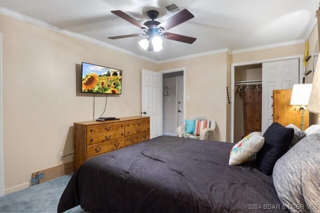 bedroom with carpet, a closet, ceiling fan, and crown molding