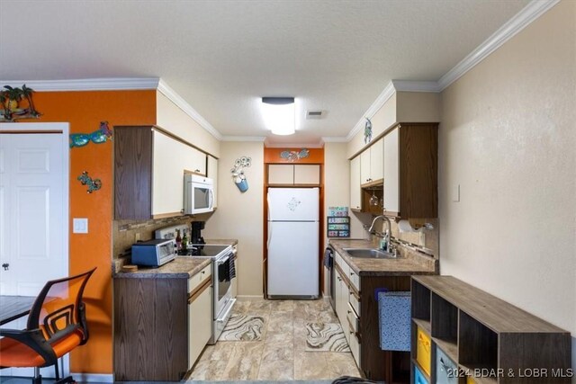 kitchen featuring ornamental molding, a textured ceiling, white appliances, sink, and white cabinets