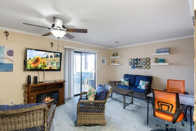 living room featuring ceiling fan, light carpet, and ornamental molding