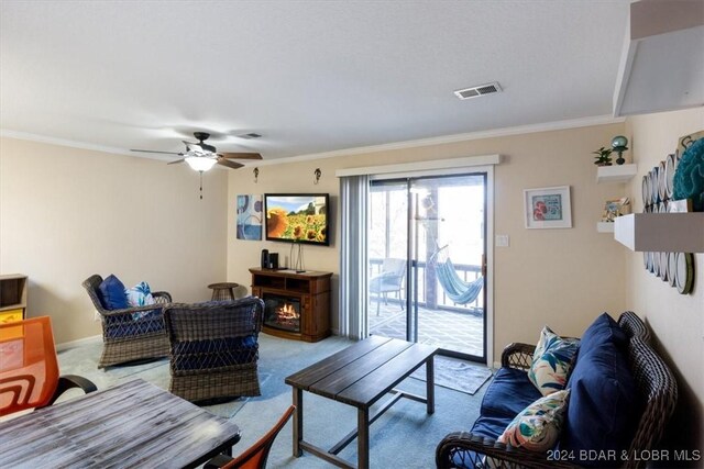 living room with light colored carpet, ceiling fan, and crown molding