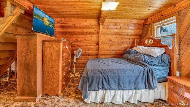 bedroom with carpet floors, wood ceiling, and wood walls