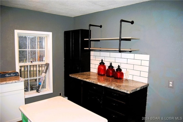 kitchen featuring white cabinets and tasteful backsplash