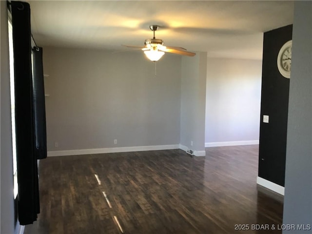 unfurnished room featuring dark hardwood / wood-style flooring and ceiling fan