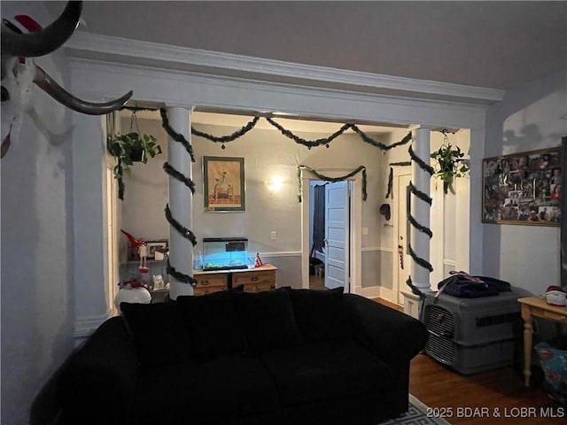 living room with hardwood / wood-style flooring and ornamental molding