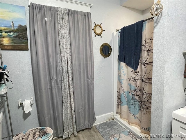 bathroom with walk in shower and hardwood / wood-style flooring