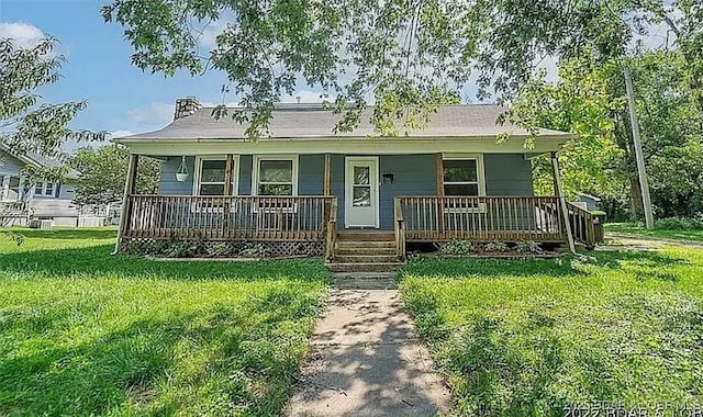 view of front of home with a front yard and a porch